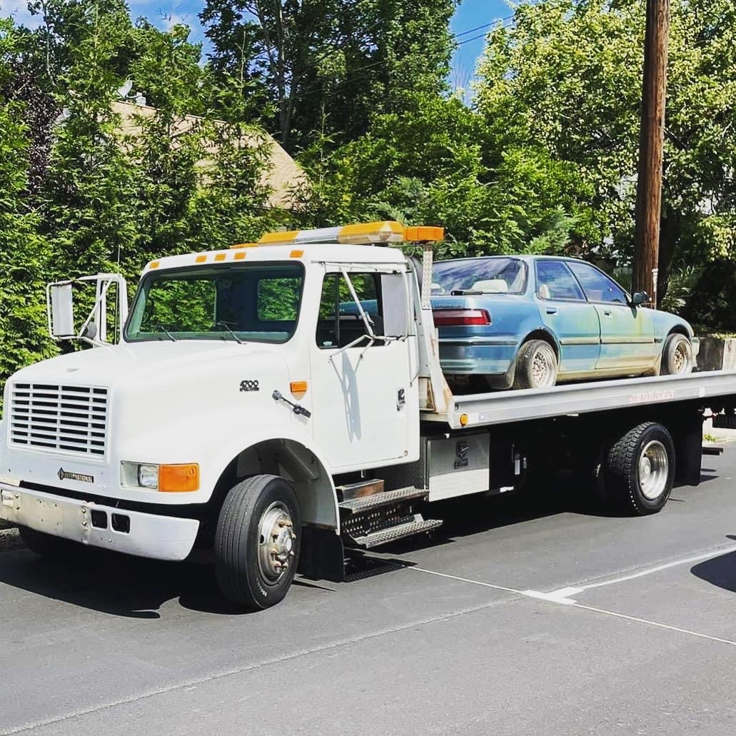Flatbed carrier serving Milford CT vehicle transport customers