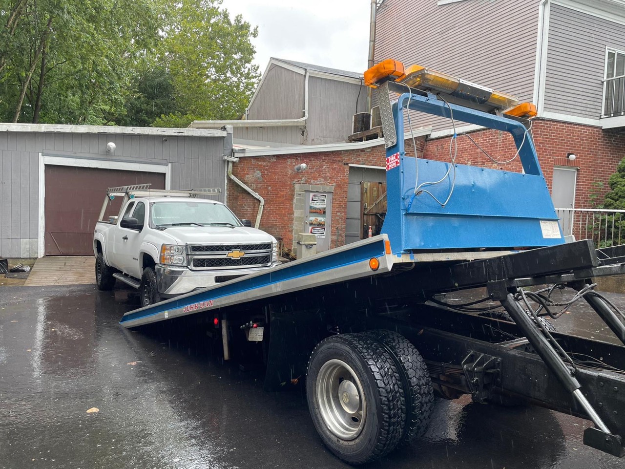 Pickup being loaded onto flatbed truck